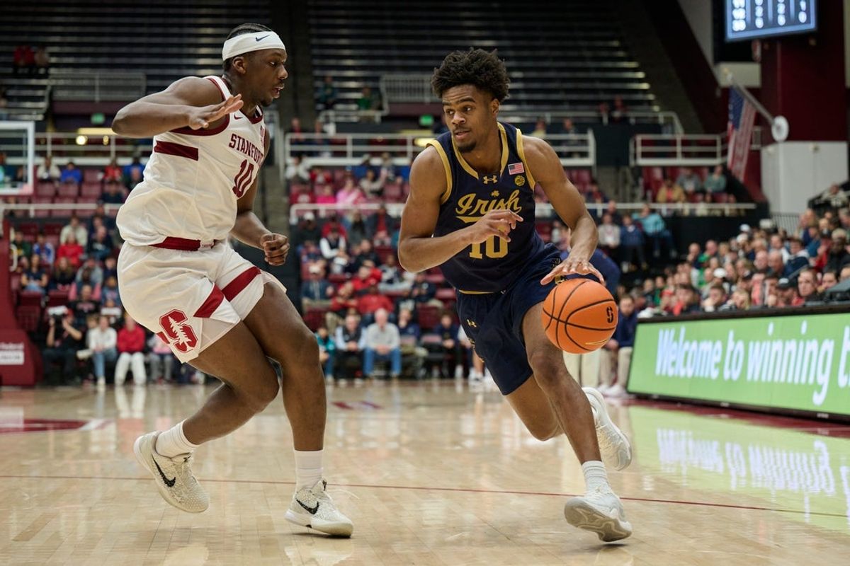 Dec 30, 2025; Stanford, California, USA; Notre Dame Fighting Irish guard Jalen Haralson (10) drives to the basket against Stanford Cardinal forward Chisom Okpara (10) during the first half at Maples Pavilion. Mandatory Credit: Robert Edwards-Imagn Images