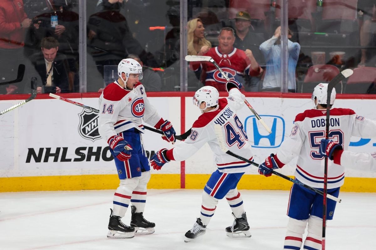 Dec 30, 2025; Sunrise, Florida, USA; Montreal Canadiens center Nick Suzuki (14) celebrates with defenseman Lane Hutson (48) after scoring against the Florida Panthers during overtime at Amerant Bank Arena. Mandatory Credit: Sam Navarro-Imagn Images