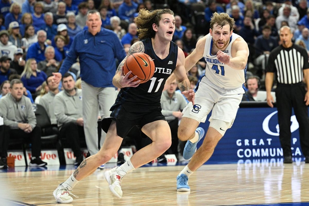 Dec 30, 2025; Omaha, Nebraska, USA; Butler Bulldogs guard Finley Bizjack (11) drives against Creighton Bluejays forward Isaac Traudt (41) during the first half at CHI Health Center Omaha. Mandatory Credit: Steven Branscombe-Imagn Images