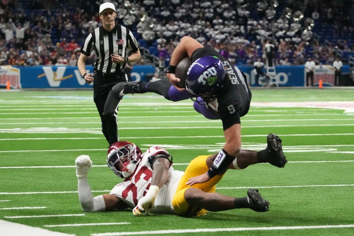 Dec 30, 2025; San Antonio, TX, USA; TCU Horned Frogs quarterback Ken Seals (9) carries the ball against Southern California Trojans linebacker Desman Stephens II (23) in the first half during the Alamo Bowl at Alamodome. Mandatory Credit: Kirby Lee-Imagn Images