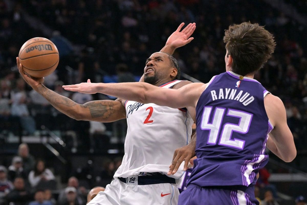 Dec 30, 2025; Inglewood, California, USA;  Los Angeles Clippers forward Kawhi Leonard (2) is defended by Sacramento Kings center Maxime Raynaud (42) as he drives to the basket in the first half at Intuit Dome. Mandatory Credit: Jayne Kamin-Oncea-Imagn Images