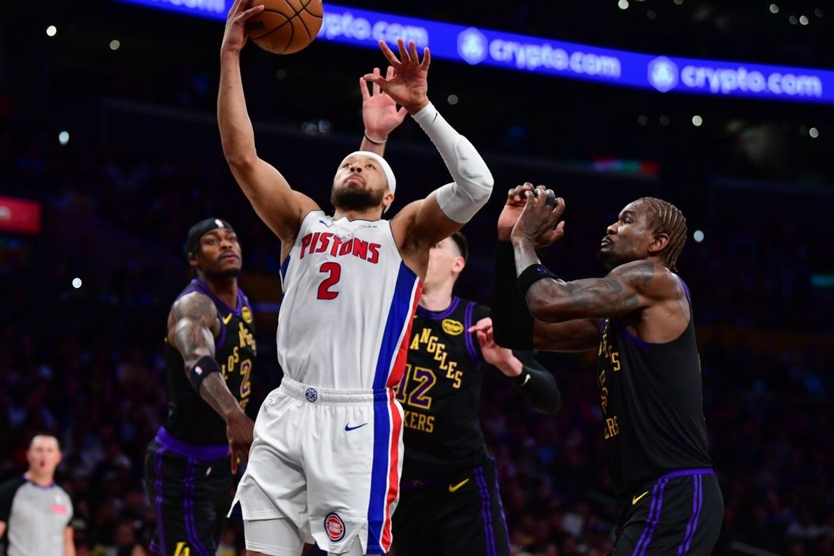 Dec 30, 2025; Los Angeles, California, USA; Detroit Pistons guard Cade Cunningham (2) moves to the basket ahead of Los Angeles Lakers center Deandre Ayton (5) during the first half at Crypto.com Arena. Mandatory Credit: Gary A. Vasquez-Imagn Images