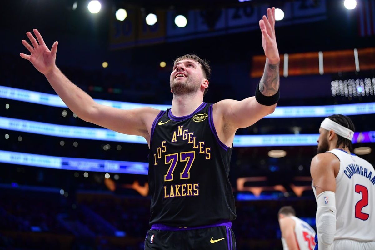Dec 30, 2025; Los Angeles, California, USA; Los Angeles Lakers guard Luka Doncic (77) reacts after scoring a basket against the Detroit Pistons during the second half at Crypto.com Arena. Mandatory Credit: Gary A. Vasquez-Imagn Images