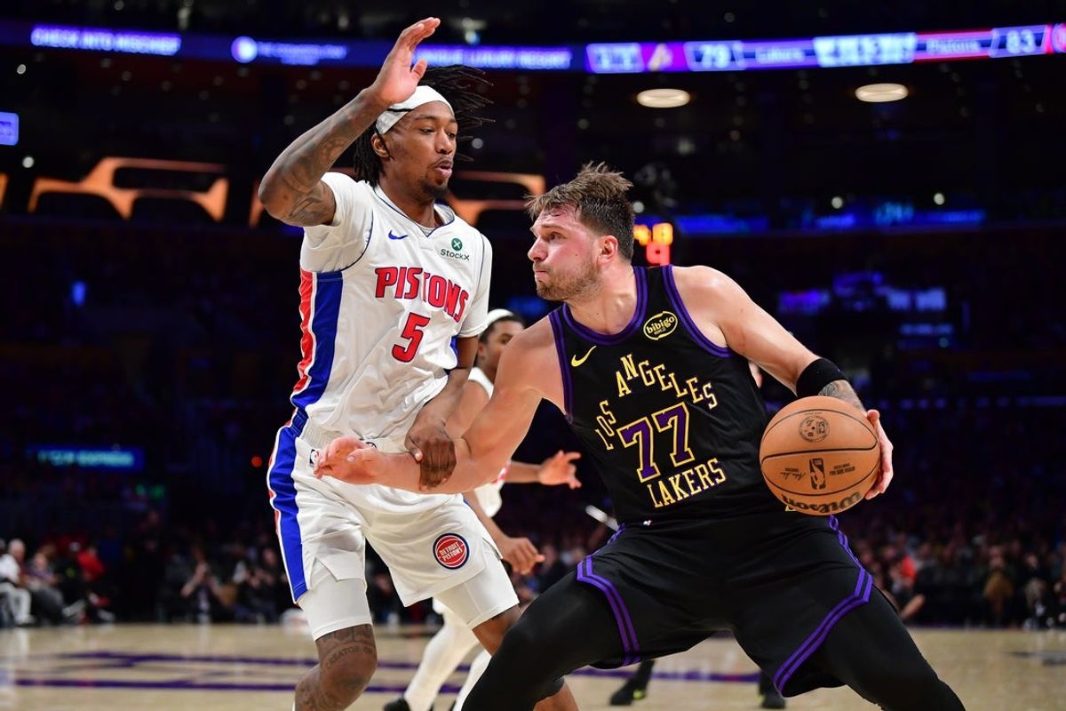 Dec 30, 2025; Los Angeles, California, USA; Los Angeles Lakers guard Luka Doncic (77) moves the ball against Detroit Pistons forward Ronald Holland II (5) during the second half at Crypto.com Arena. Mandatory Credit: Gary A. Vasquez-Imagn Images