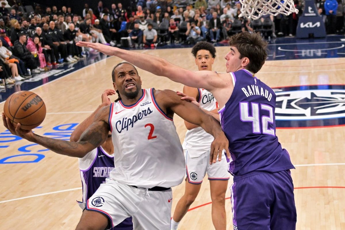 Dec 30, 2025; Inglewood, California, USA;  Los Angeles Clippers forward Kawhi Leonard (2) is defended by Sacramento Kings center Maxime Raynaud (42) as he drives to the basket in the first half at Intuit Dome. Mandatory Credit: Jayne Kamin-Oncea-Imagn Images