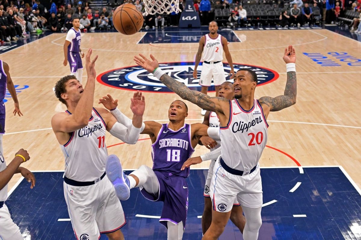 Dec 30, 2025; Inglewood, California, USA;  Los Angeles Clippers center Brook Lopez (11) and forward John Collins (20) reach for a rebound after a missed shot by Sacramento Kings guard Russell Westbrook (18) in the second half at Intuit Dome. Mandatory Credit: Jayne Kamin-Oncea-Imagn Images