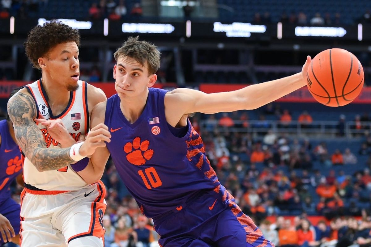 Dec 31, 2025; Syracuse, New York, USA; Clemson Tigers forward Jake Wahlin (10) drives against Syracuse Orange guard Nate Kingz (4) during the first half at the JMA Wireless Dome. Mandatory Credit: Rich Barnes-Imagn Images