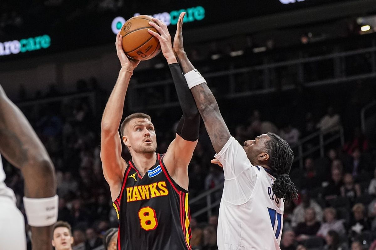 Dec 31, 2025; Atlanta, Georgia, USA; Atlanta Hawks center Kristaps Porzingis (8) shoots over Minnesota Timberwolves center Naz Reid (11) during the first half at State Farm Arena. Mandatory Credit: Dale Zanine-Imagn Images