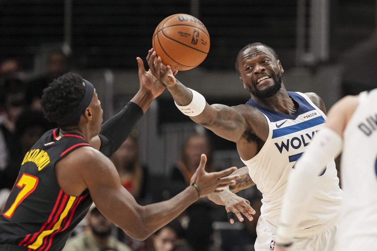 Dec 31, 2025; Atlanta, Georgia, USA; Minnesota Timberwolves forward Julius Randle (30) reaches for a rebound against Atlanta Hawks forward Onyeka Okongwu (17) during the first half at State Farm Arena. Mandatory Credit: Dale Zanine-Imagn Images