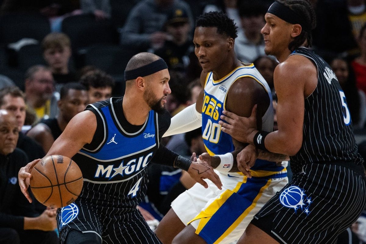 Dec 31, 2025; Indianapolis, Indiana, USA;  Orlando Magic guard Jalen Suggs (4) dribbles the ball while Indiana Pacers guard/forward Bennedict Mathurin (00) defends in the first half at Gainbridge Fieldhouse. Mandatory Credit: Trevor Ruszkowski-Imagn Images