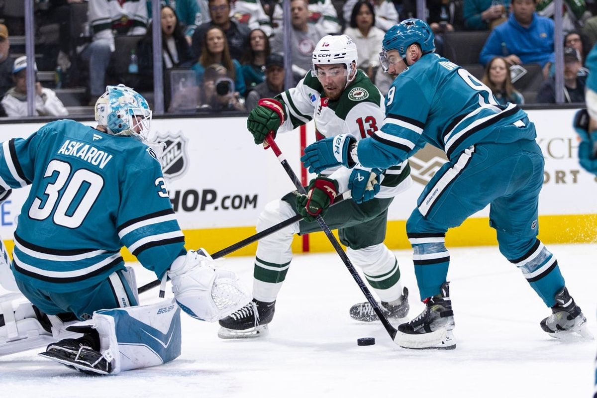 Dec 31, 2025; San Jose, California, USA;  San Jose Sharks defenseman Dmitry Orlov (9) and goaltender Yaroslav Askarov (30) defend against  shot by Minnesota Wild center Yakov Trenin (13) during the first period at SAP Center at San Jose. Mandatory Credit: John Hefti-Imagn Images