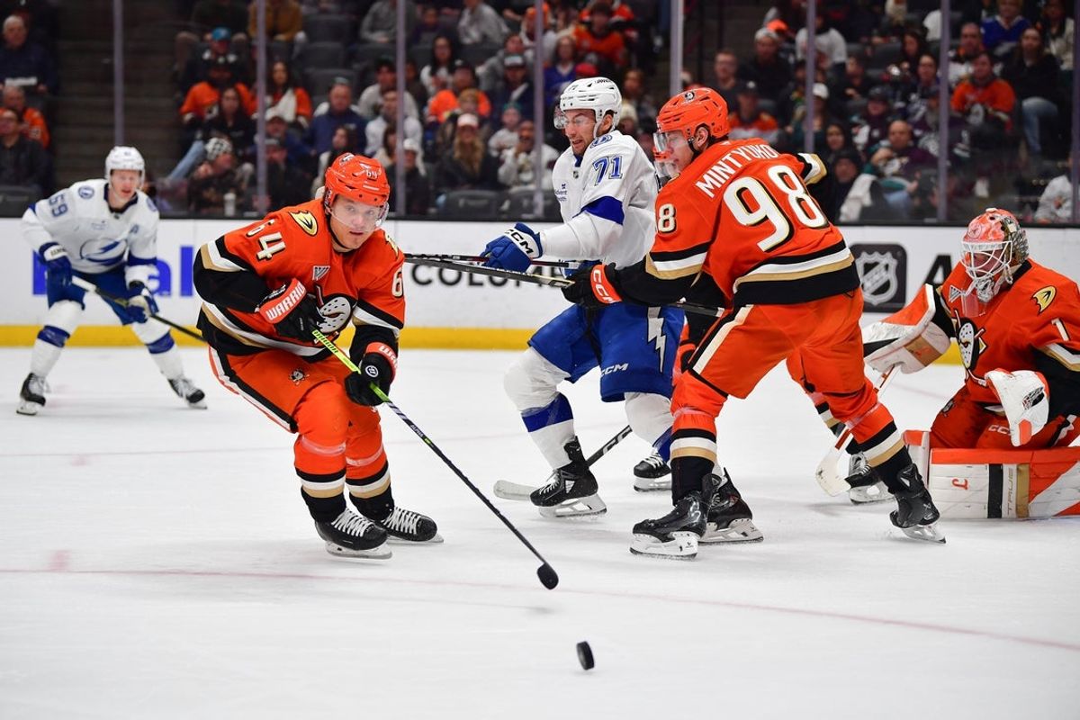 Dec 31, 2025; Anaheim, California, USA; Anaheim Ducks center Mikael Granlund (64) recovers the puck against the Tampa Bay Lightning during the first period at Honda Center. Mandatory Credit: Gary A. Vasquez-Imagn Images
