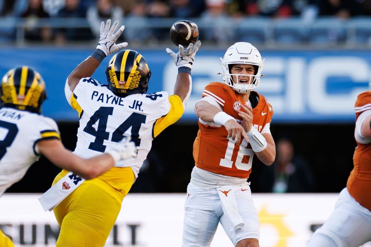 Dec 31, 2025; Orlando, FL, USA; Michigan Wolverines defensive lineman Damon Payne (44) tips a pass from Texas Longhorns quarterback Arch Manning (16) during the first half at Camping World Stadium. Mandatory Credit: Matt Pendleton-Imagn Images
