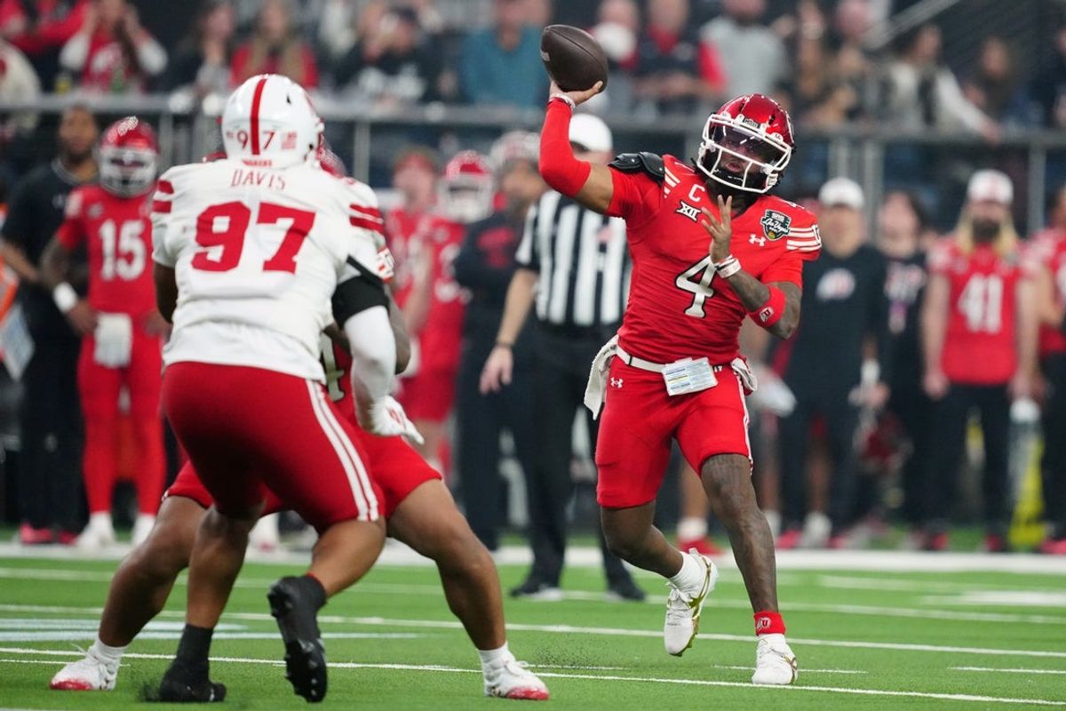 Dec 31, 2025; Las Vegas, NV, USA; Utah Utes quarterback Devon Dampier (4) throws the ball against Nebraska Cornhuskers defensive lineman Keona Davis (97) in the first half during the SRS Distribution Las Vegas Bowl at Allegiant Stadium. Mandatory Credit: Kirby Lee-Imagn Images