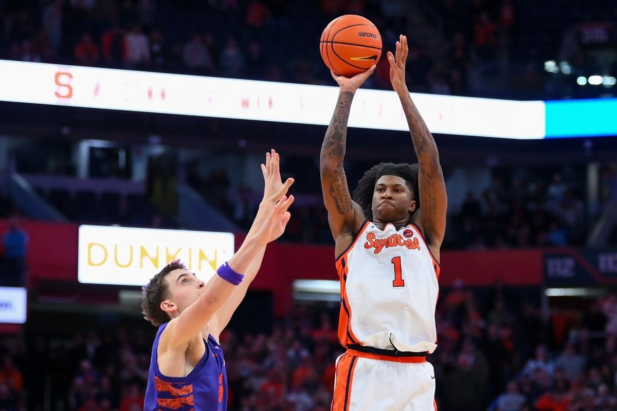 Dec 31, 2025; Syracuse, New York, USA; Syracuse Orange forward Donnie Freeman (1) shoots against Clemson Tigers forward Jake Wahlin (left) during the second half at the JMA Wireless Dome. Mandatory Credit: Rich Barnes-Imagn Images