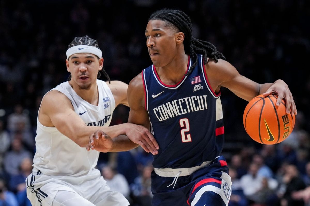 Dec 31, 2025; Cincinnati, Ohio, USA;  UConn Huskies guard Silas Demary Jr. (2) controls the ball against Xavier Musketeers guard Malik Messina-Moore (1) in the second half at the Cintas Center. Mandatory Credit: Aaron Doster-Imagn Images