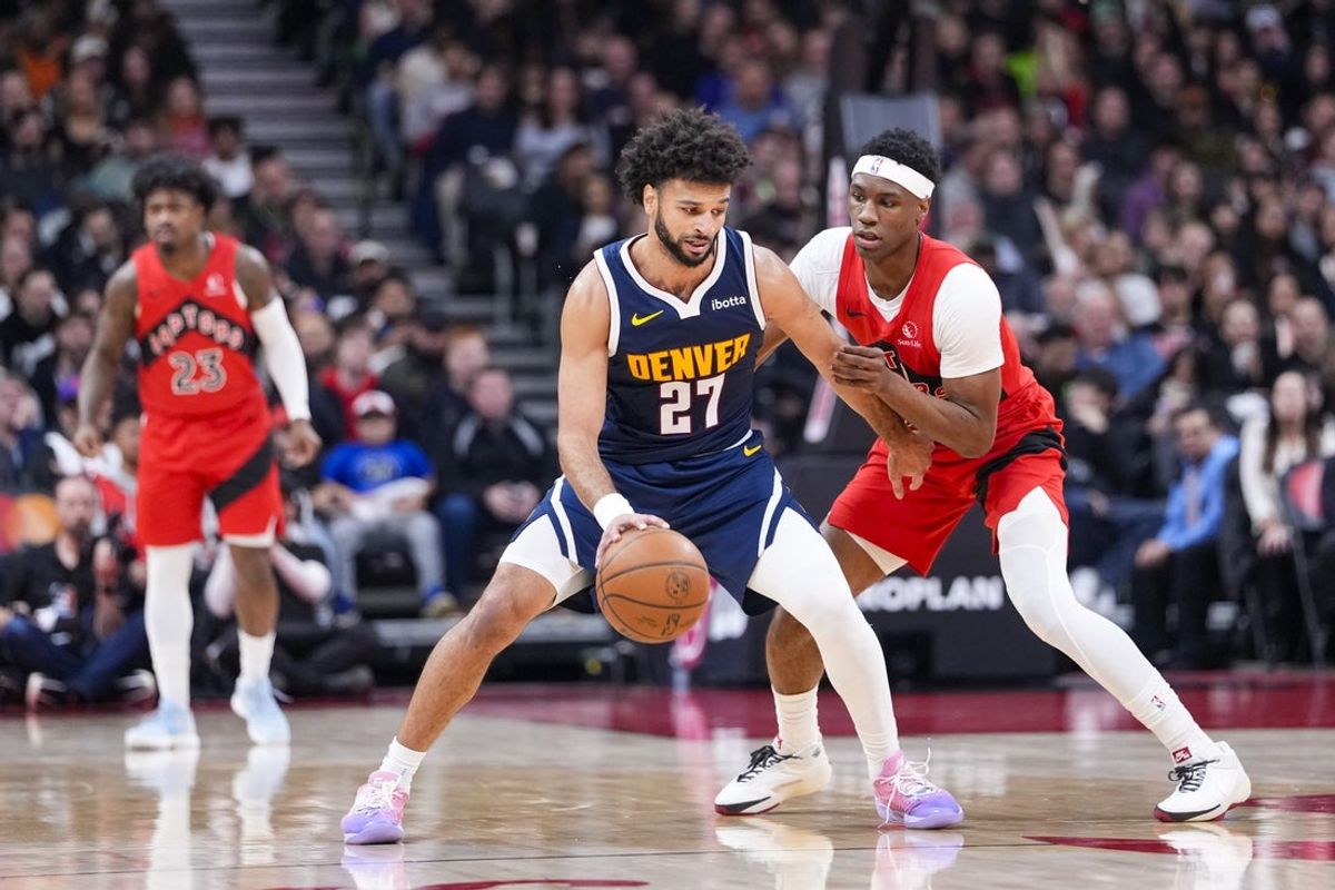 Dec 31, 2025; Toronto, Ontario, CAN; Denver Nuggets guard Jamal Murray (27) dribbles against Toronto Raptors guard Ja'Kobe Walter (14) during the first half at Scotiabank Arena. Mandatory Credit: Kevin Sousa-Imagn Images