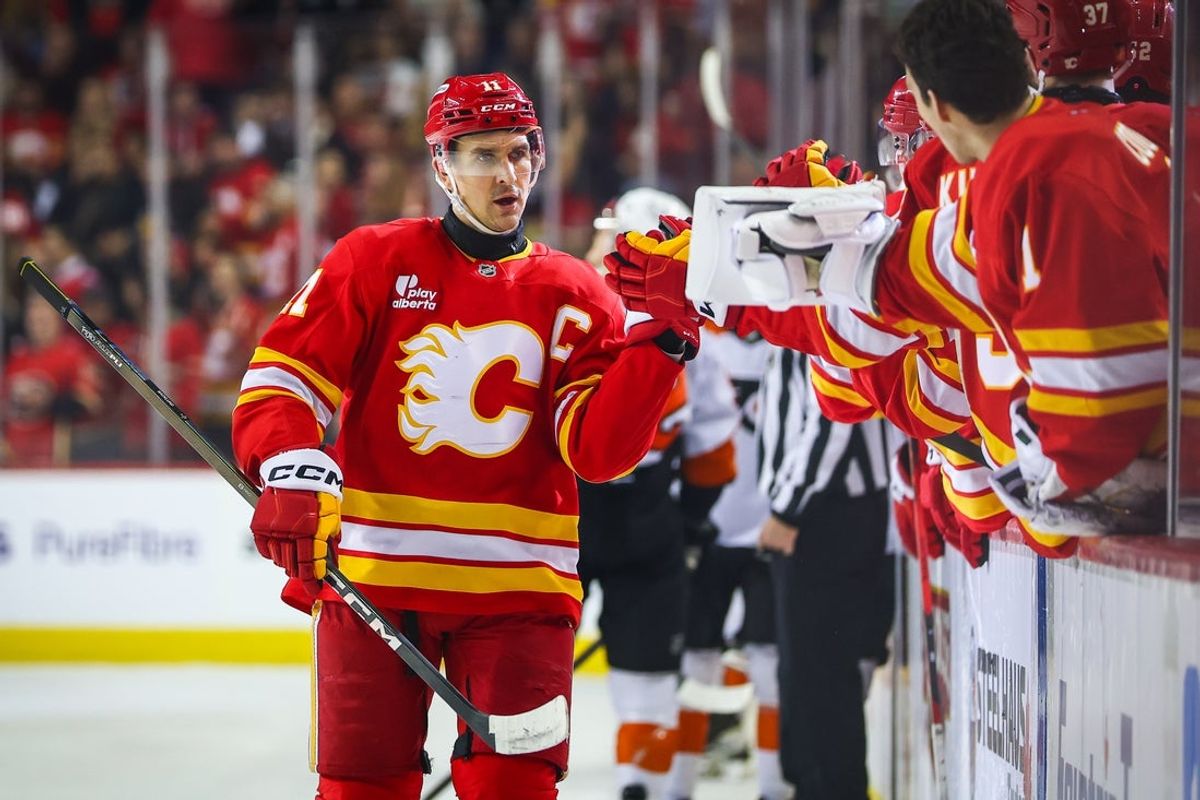 Dec 31, 2025; Calgary, Alberta, CAN; Calgary Flames center Mikael Backlund (11) celebrates his goal with teammates against the Philadelphia Flyers during the first period at Scotiabank Saddledome. Mandatory Credit: Sergei Belski-Imagn Images