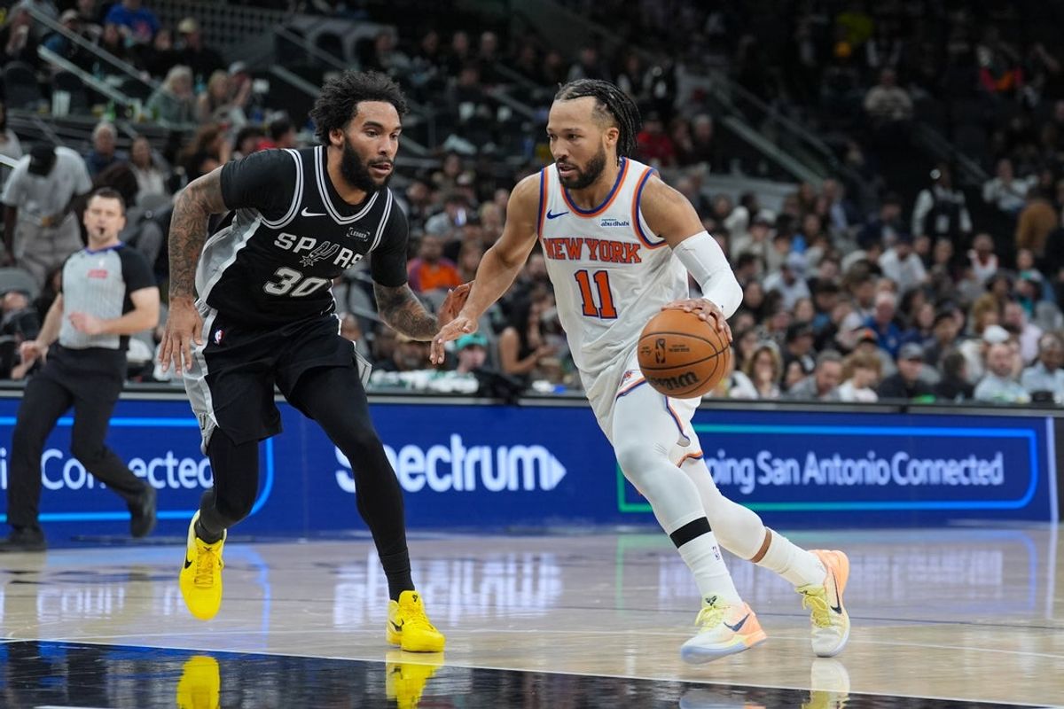 Dec 31, 2025; San Antonio, Texas, USA;  New York Knicks guard Jalen Brunson (11) dribbles against San Antonio Spurs forward Julian Champagnie (30) in the second half at Frost Bank Center. Mandatory Credit: Daniel Dunn-Imagn Images