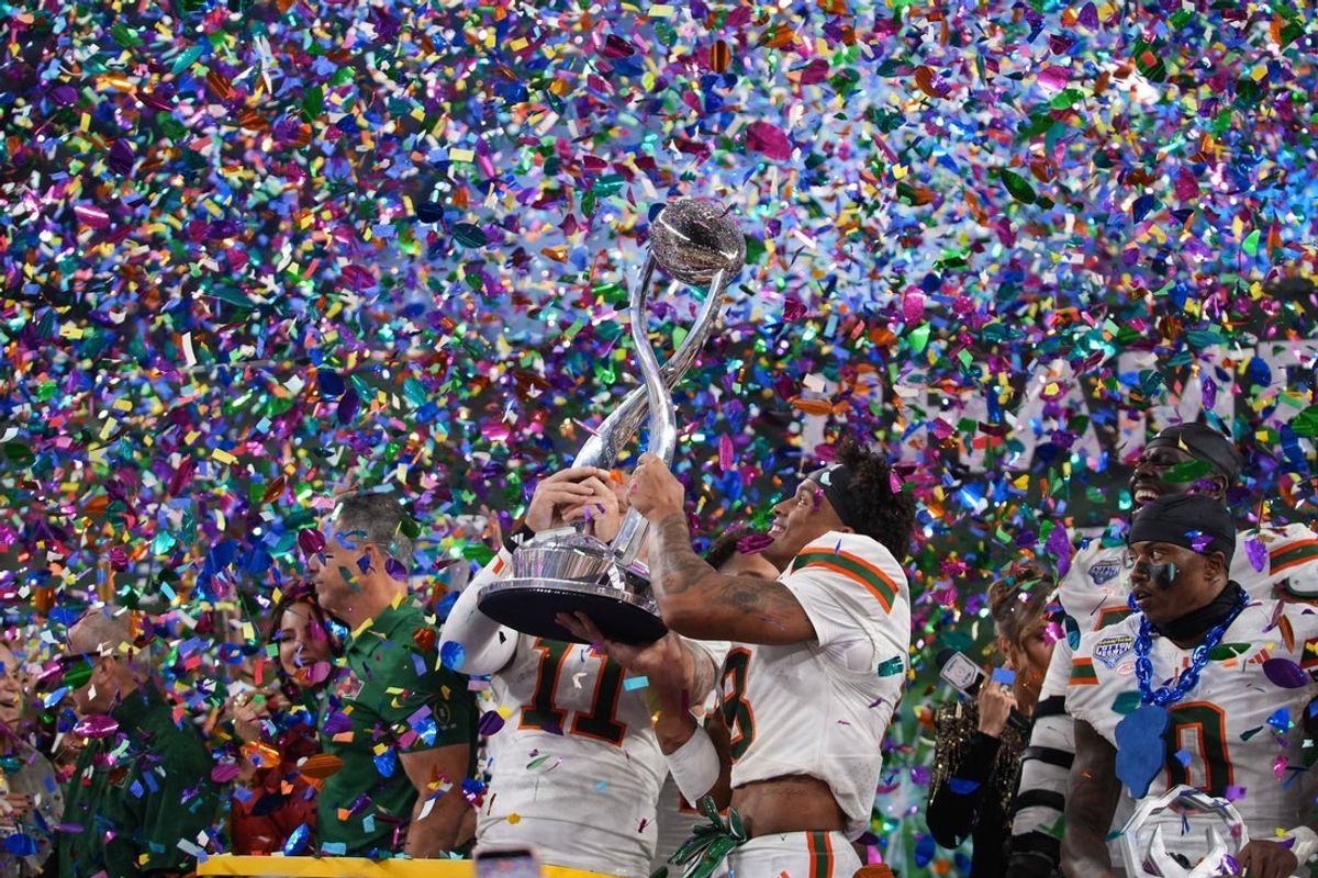 Dec 31, 2025; Arlington, TX, USA; Miami Hurricanes quarterback Carson Beck (11) and Miami Hurricanes defensive back Jakobe Thomas (8) lift the Cotton Bowl trophy after defeating the Ohio State Buckeyes during the 2025 Cotton Bowl and quarterfinal game of the College Football Playoff at AT&T Stadium. Mandatory Credit: Raymond Carlin III-Imagn Images