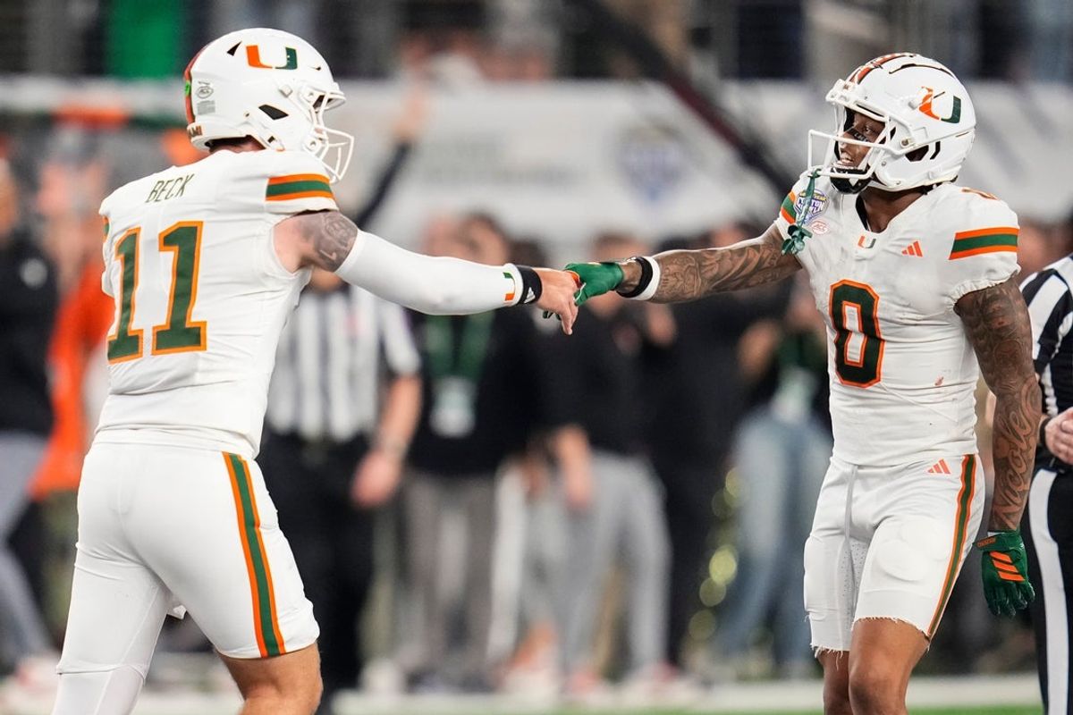 Miami Hurricanes quarterback Carson Beck (11) celebrates with wide receiver Keelan Marion (0) the Cotton Bowl at AT&T Stadium in Arlington, Texas for the College Football Playoff quarterfinal game against the Ohio State Buckeyes on Dec. 31, 2025. Ohio State lost 24-14.