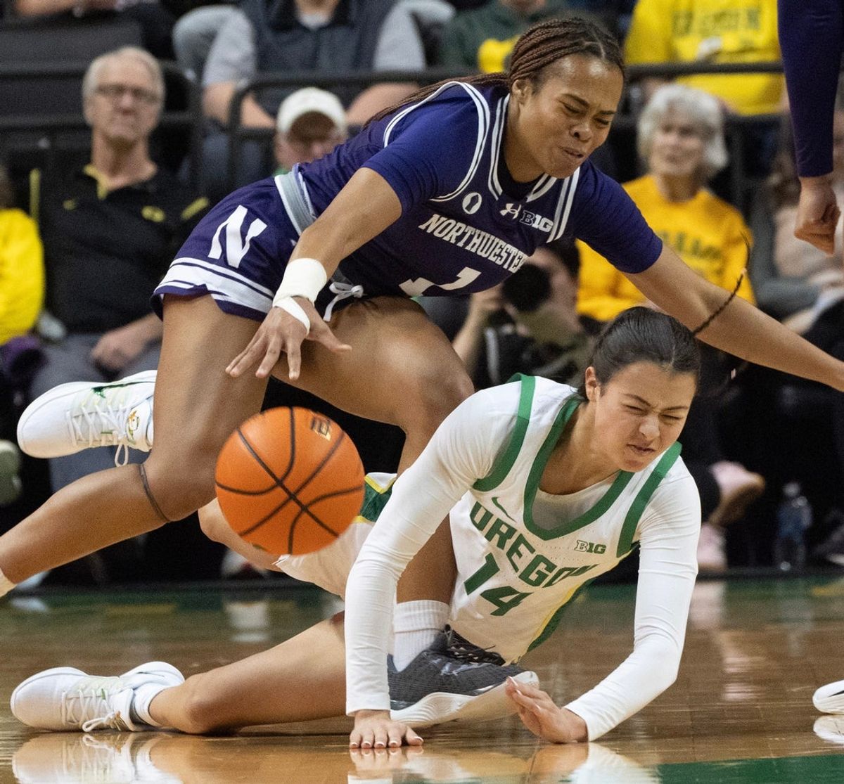 Oregon’s Ari Long, right, draws a player control foul against Northwestern’s Xamiya Walton during the first half at Matthew Knight Arena Jan. 1, 2026.