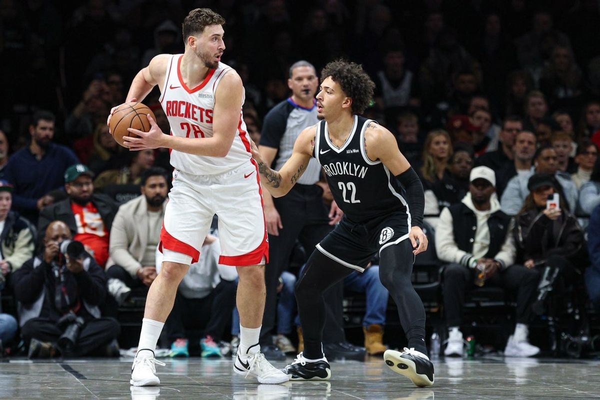 Jan 1, 2026; Brooklyn, New York, USA; Houston Rockets center Alperen Sengun (28) is guarded by Brooklyn Nets forward Jalen Wilson (22) during the first half at Barclays Center. Mandatory Credit: Vincent Carchietta-Imagn Images