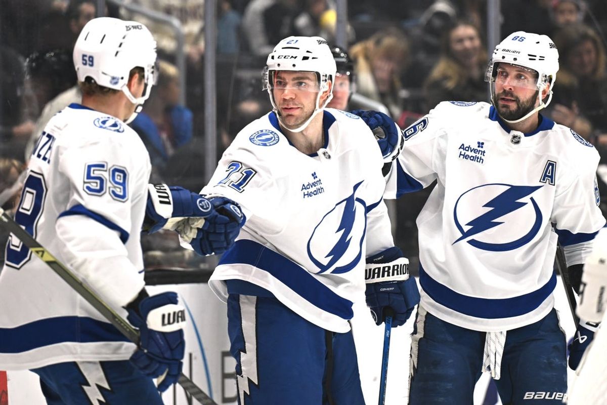 Jan 1, 2026; Los Angeles, California, USA; Tampa Bay Lightning center Jake Guentzel (59), Tampa Bay Lightning center Brayden Point (21), and Tampa Bay Lightning right wing Nikita Kucherov (86) celebrate a goal during the first period against the Los Angeles Kings at Crypto.com Arena. Mandatory Credit: Griffin Hooper-Imagn Images