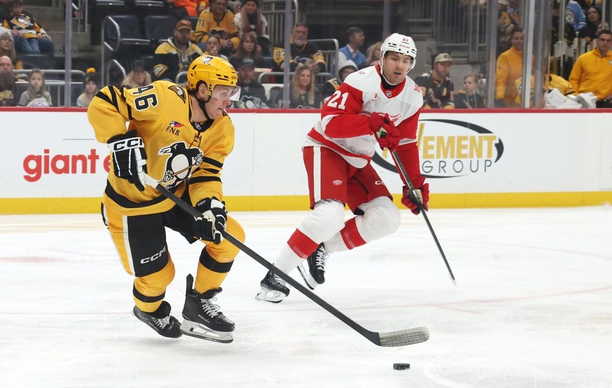 Jan 1, 2026; Pittsburgh, Pennsylvania, USA;  Pittsburgh Penguins center Blake Lizotte (46) moves the puck against Detroit Red Wings left wing James van Riemsdyk (21) during the first period at PPG Paints Arena. Mandatory Credit: Charles LeClaire-Imagn Images