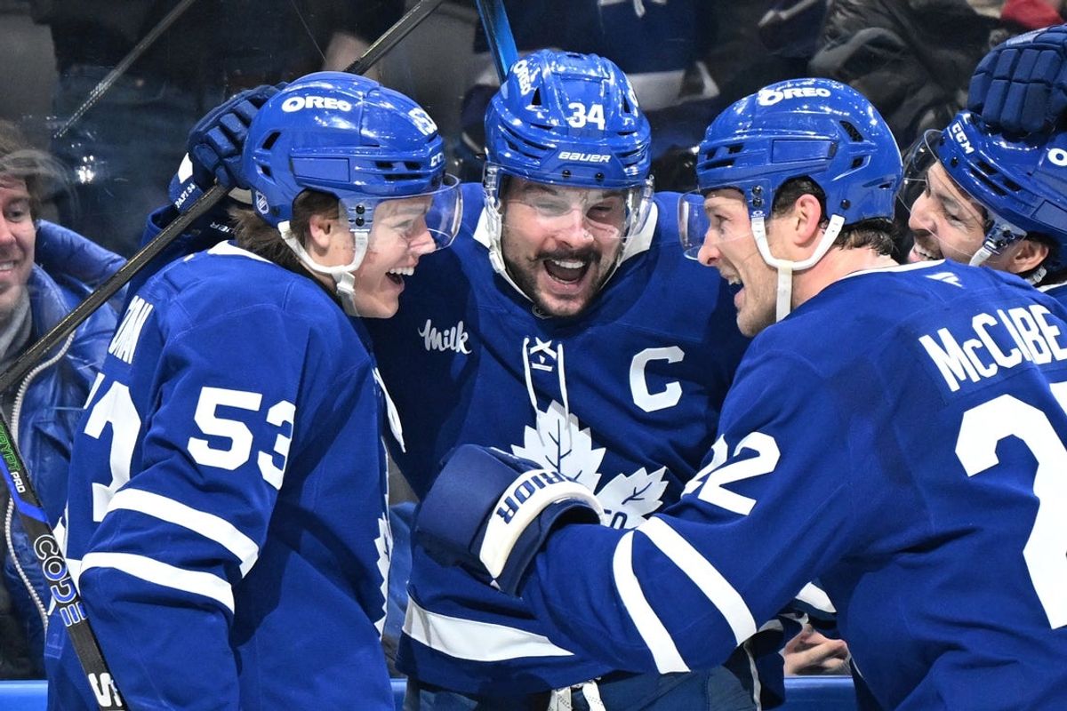 Jan 1, 2026; Toronto, Ontario, CAN;  Toronto Maple Leafs forward Auston Matthews (34) celebrates with forwards Easton Cowan (53) and Nick Robertson (89) and defensemen Jake McCabe (22) and Troy Stecher (28) after scoring his third goal of the game against the Winnipeg Jets in the third period at Scotiabank Arena. Mandatory Credit: Dan Hamilton-Imagn Images