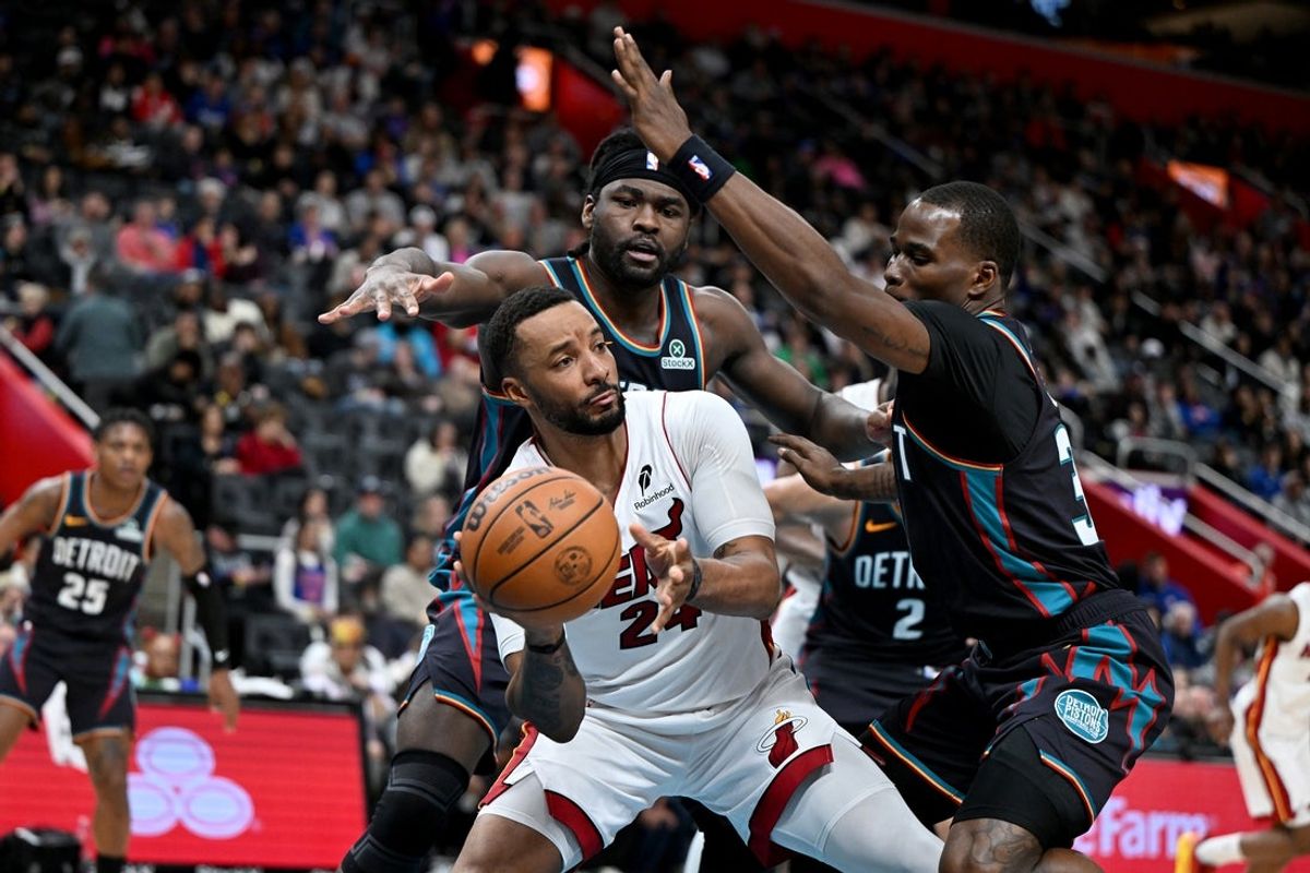 Jan 1, 2026; Detroit, Michigan, USA; Miami Heat guard Norman Powell (24) passes the ball while being double teamed by Detroit Pistons forward Isaiah Stewart (top) and Pistons guard Javonte Green (right) in the fourth quarter at Little Caesars Arena. Mandatory Credit: Lon Horwedel-Imagn Images