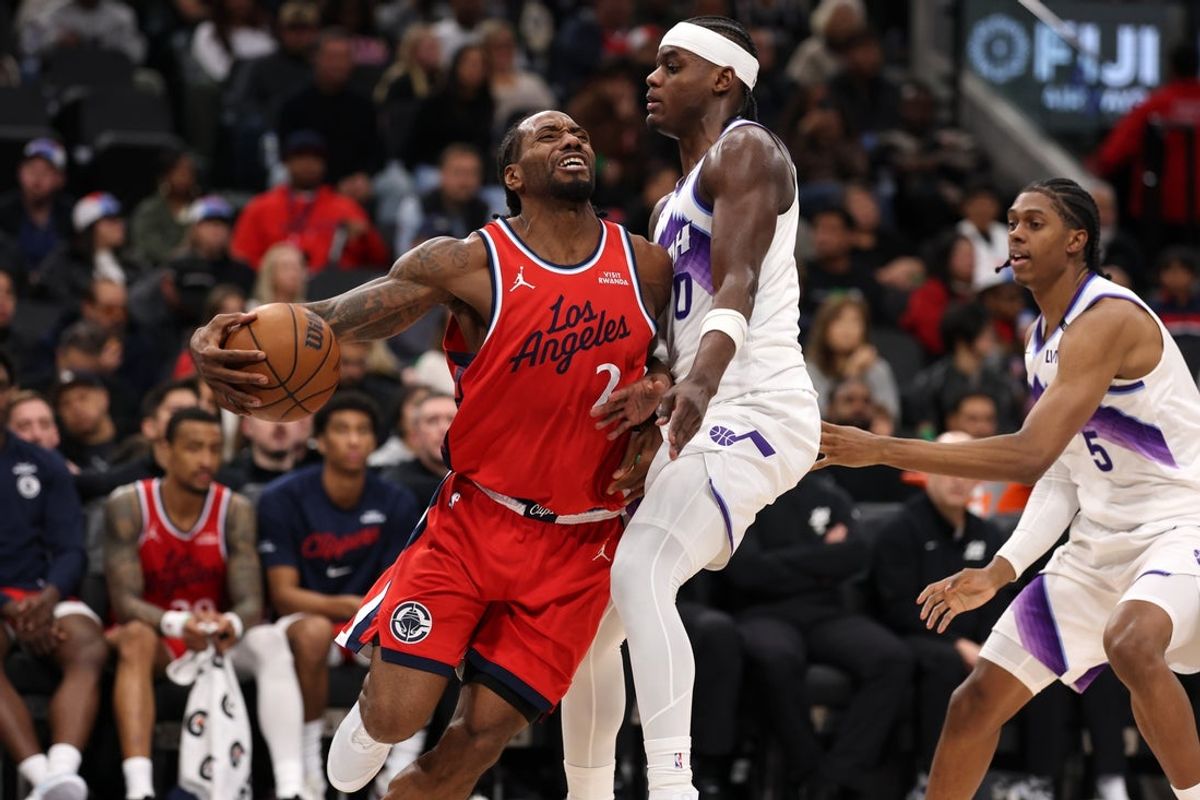 Jan 1, 2026; Inglewood, California, USA;  Los Angeles Clippers forward Kawhi Leonard (2) is fouled by Utah Jazz forward Taylor Hendricks (0) during the third quarter at Intuit Dome. Mandatory Credit: Kiyoshi Mio-Imagn Images