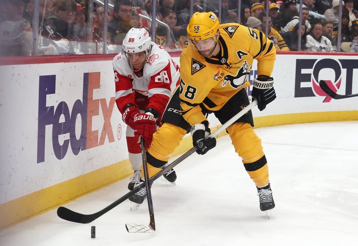 Jan 1, 2026; Pittsburgh, Pennsylvania, USA;  Detroit Red Wings right wing Patrick Kane (88) and Pittsburgh Penguins defenseman Kris Letang (58) chase the puck during the third period at PPG Paints Arena. Mandatory Credit: Charles LeClaire-Imagn Images
