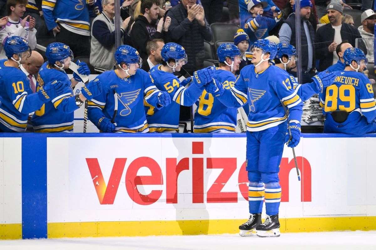 Jan 2, 2026; St. Louis, Missouri, USA; St. Louis Blues right wing Alexey Toropchenko (13) is congratulated by teammates after scoring against the Vegas Golden Knights during the first period at Enterprise Center. Mandatory Credit: Jeff Curry-Imagn Images
