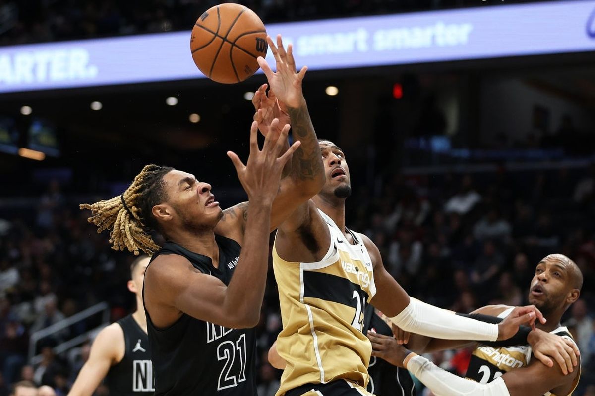 Jan 2, 2026; Washington, District of Columbia, USA; Washington Wizards center Alex Sarr (20) swats the ball away from Brooklyn Nets forward Noah Clowney (21) during the first half at Capital One Arena. Mandatory Credit: Daniel Kucin Jr.-Imagn Images