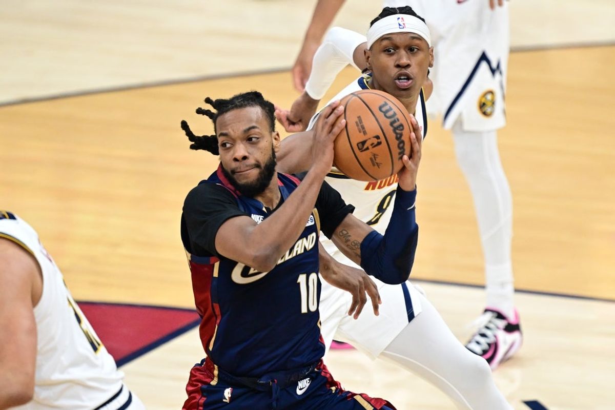 Jan 2, 2026; Cleveland, Ohio, USA; Cleveland Cavaliers guard Darius Garland (10) looks to pass while being defended by Denver Nuggets guard Peyton Watson (8) during the first half at Rocket Arena. Mandatory Credit: David Dermer-Imagn Images