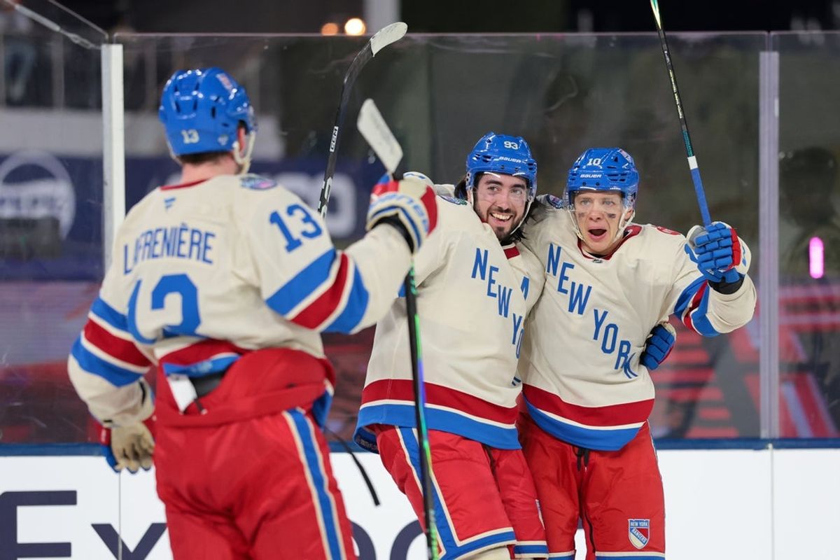 Jan 2, 2026; Miami, Florida, USA; New York Rangers left wing Artemi Panarin (10) celebrates with left wing Alexis Lafreniere (13) and center Mika Zibanejad (93) after scoring a goal against the Florida Panthers during the first period in the 2026 Winter Classic ice hockey game at loanDepot Park. Mandatory Credit: Sam Navarro-Imagn Images