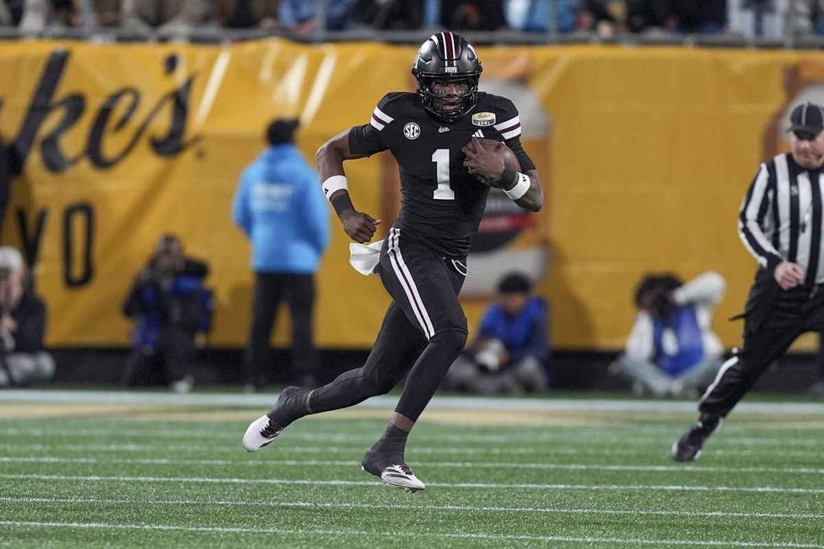 Jan 2, 2026; Charlotte, NC, USA; Mississippi State Bulldogs quarterback Kamario Taylor (1) runs for yardage against the Wake Forest Demon Deacons during the first quarter at Bank of America Stadium. Mandatory Credit: Jim Dedmon-Imagn Images