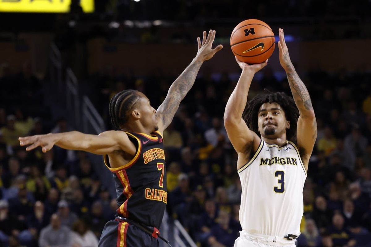Jan 2, 2026; Ann Arbor, Michigan, USA;  Michigan Wolverines guard Elliot Cadeau (3) shoots on Southern California Trojans guard Jordan Marsh (7) in the first half at Crisler Center. Mandatory Credit: Rick Osentoski-Imagn Images