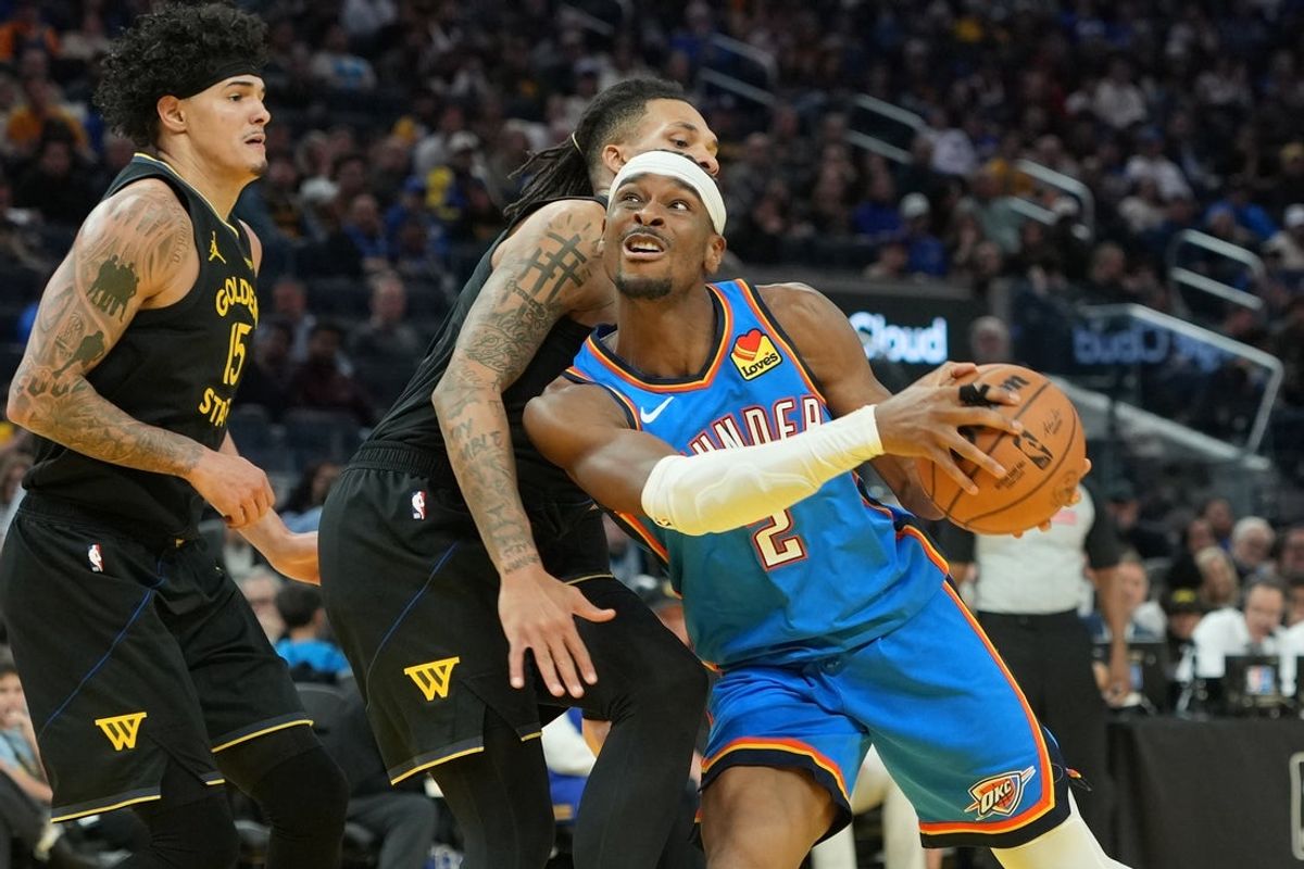 Jan 2, 2026; San Francisco, California, USA; Oklahoma City Thunder guard Shai Gilgeous-Alexander (2) drives against Golden State Warriors guard Will Richard (center left) during the third quarter at Chase Center. Mandatory Credit: Darren Yamashita-Imagn Images