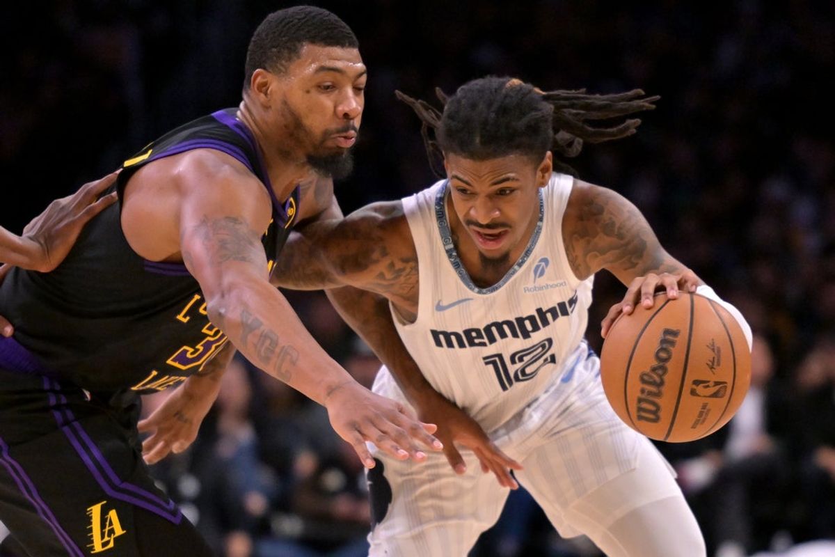 Jan 2, 2026; Los Angeles, California, USA; Los Angeles Lakers guard Marcus Smart (36) defends Memphis Grizzlies guard Ja Morant (12) as he drives to the basket in the second half at Crypto.com Arena. Mandatory Credit: Jayne Kamin-Oncea-Imagn Images