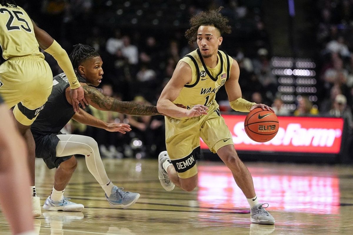 Jan 3, 2026; Winston-Salem, North Carolina, USA; Wake Forest Demon Deacons guard Nate Calmese (1) handles the ball defended by Virginia Tech Hokies guard Ben Hammond (3) during the first half at Lawrence Joel Veterans Memorial Coliseum. Mandatory Credit: Jim Dedmon-Imagn Images