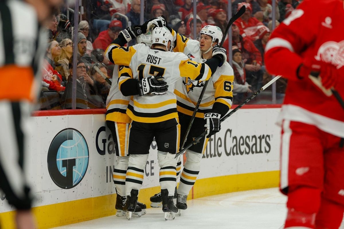 Jan 3, 2026; Detroit, Michigan, USA; Pittsburgh Penguins center Sidney Crosby (87) celebrates a goal scored in the first period with right wing Bryan Rust (17) left wing Rickard Rakell (67) during the first periodat Little Caesars Arena. Mandatory Credit: Brian Bradshaw Sevald-Imagn Images