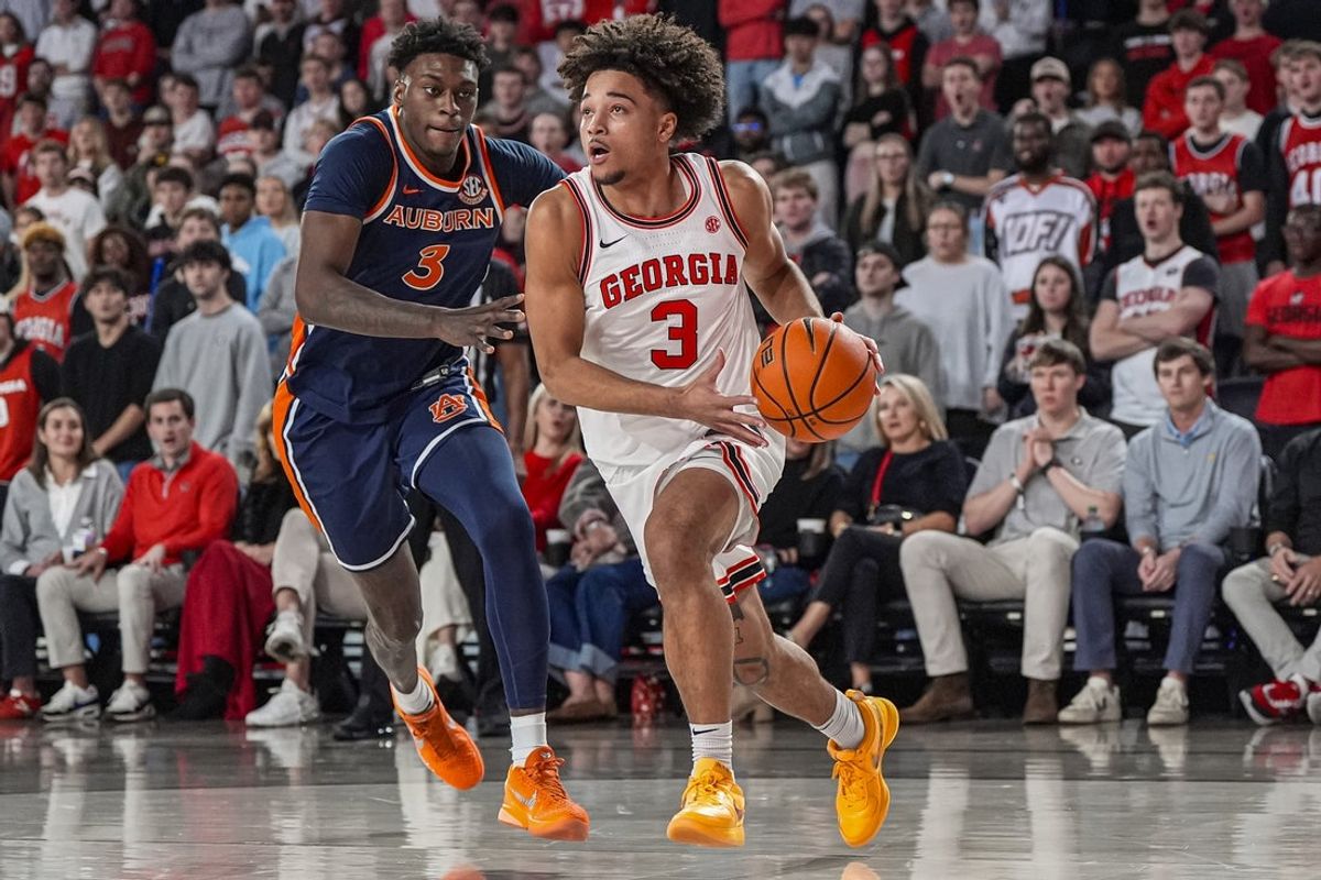 Jan 3, 2026; Athens, Georgia, USA; Georgia Bulldogs guard Jordan Ross (3) dribbles against Auburn Tigers forward Keshawn Murphy (3) during the first half at Stegeman Coliseum. Mandatory Credit: Dale Zanine-Imagn Images