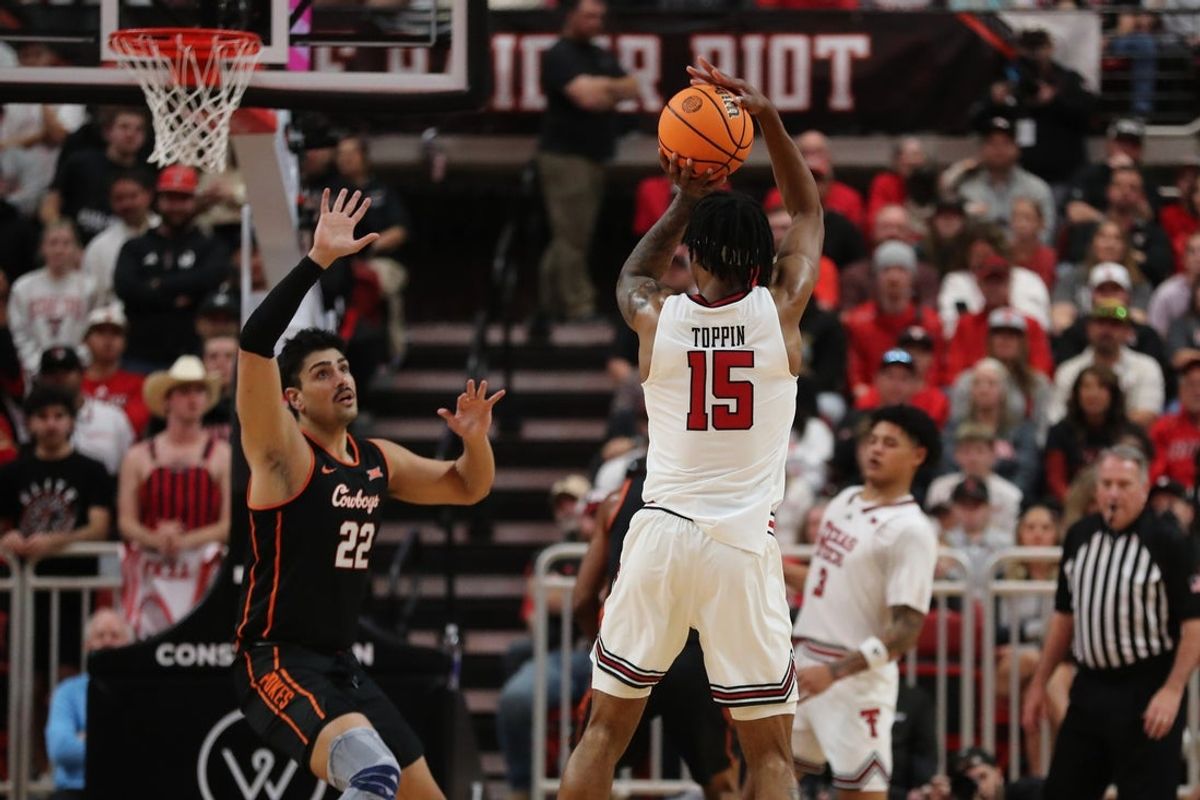 Jan 3, 2026; Lubbock, Texas, USA;  Texas Tech Red Raiders forward JT Toppin (15) shoots over Oklahoma State Cowboys forward Parsa Fallah (22) in the first half at United Supermarkets Arena. Mandatory Credit: Michael C. Johnson-Imagn Images