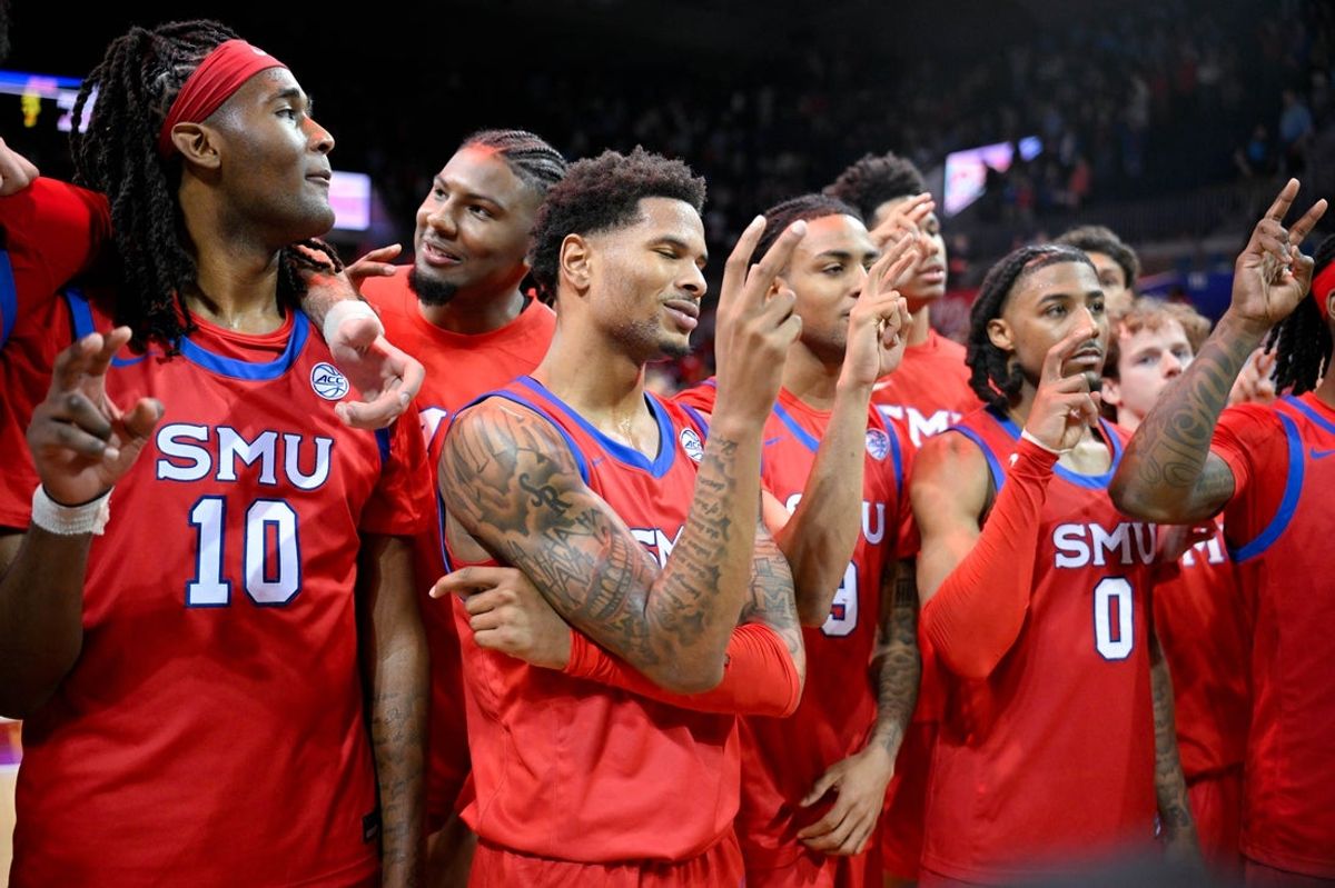 Jan 3, 2026; Dallas, Texas, USA; SMU Mustangs forward Sam Walters (4) and center Samet Yigitoglu (24) and center Jaden Toombs (10) and guard B.J. Edwards (0) celebrate on the court after the Mustangs defeat the North Carolina Tar Heels at Moody Coliseum. Mandatory Credit: Jerome Miron-Imagn Images