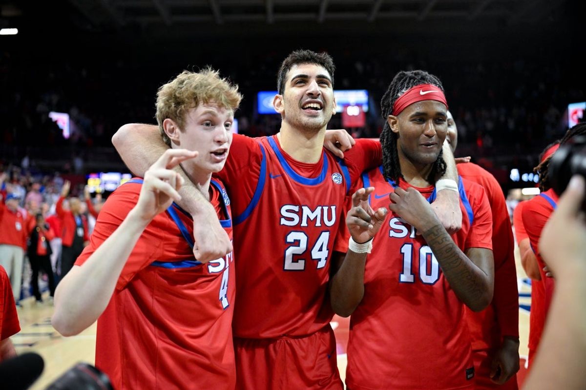 Jan 3, 2026; Dallas, Texas, USA; SMU Mustangs forward Sam Walters (4) and center Samet Yigitoglu (24) and center Jaden Toombs (10) celebrate on the court after the Mustangs defeat the North Carolina Tar Heels at Moody Coliseum. Mandatory Credit: Jerome Miron-Imagn Images