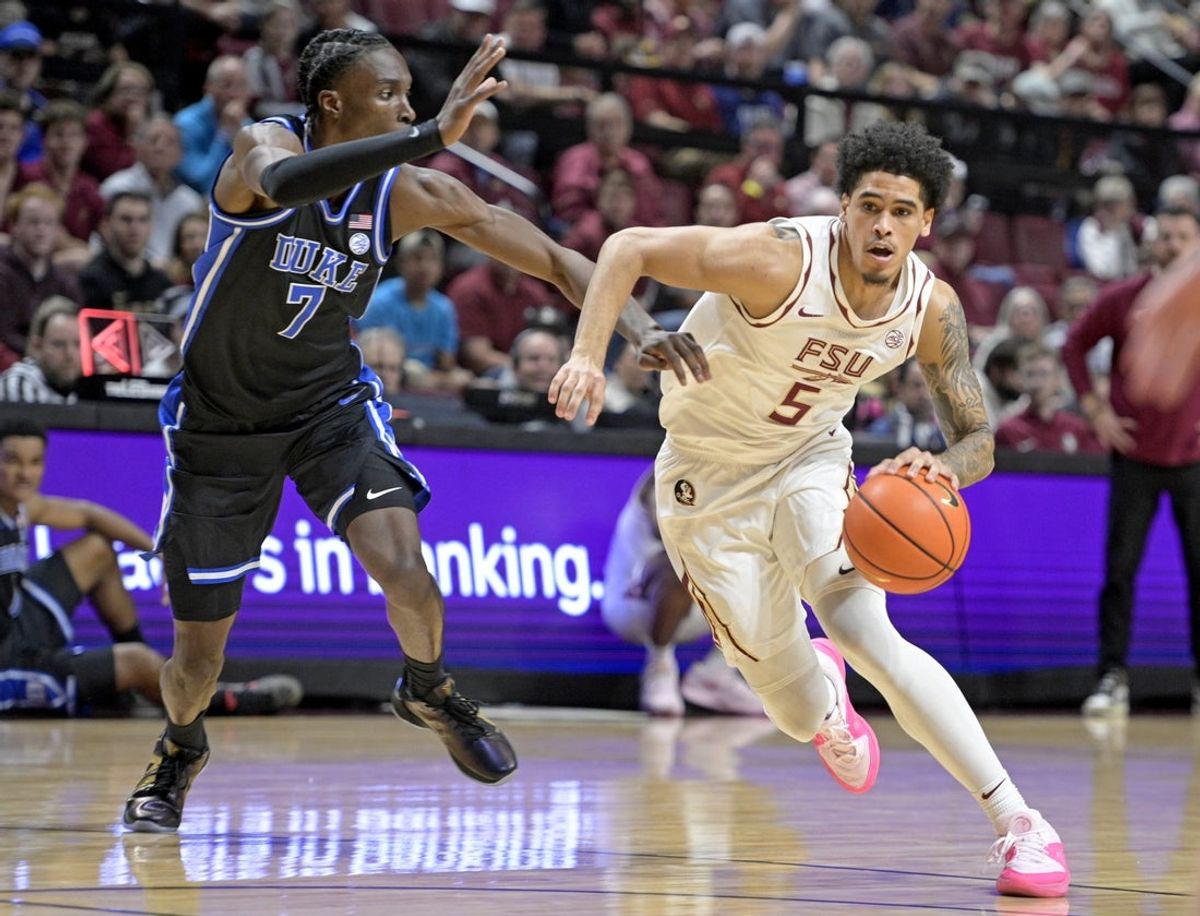 Jan 3, 2026; Tallahassee, Florida, USA; Florida State Seminoles guard Kobe MaGee (5) drives to the net past Duke Blue Devils guard Dame Sarr (7) during the first half at Donald L. Tucker Center. Mandatory Credit: Melina Myers-Imagn Images