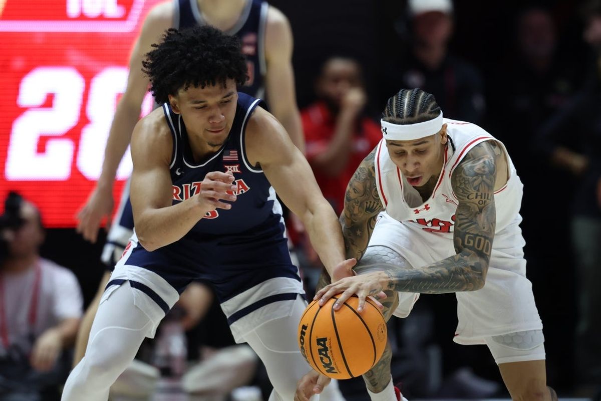 Jan 3, 2026; Salt Lake City, Utah, USA; Arizona Wildcats guard Brayden Burries (5) and Utah Utes guard Terrence Brown (2) battle for a loose ball during the first half at Jon M. Huntsman Center. Mandatory Credit: Rob Gray-Imagn Images