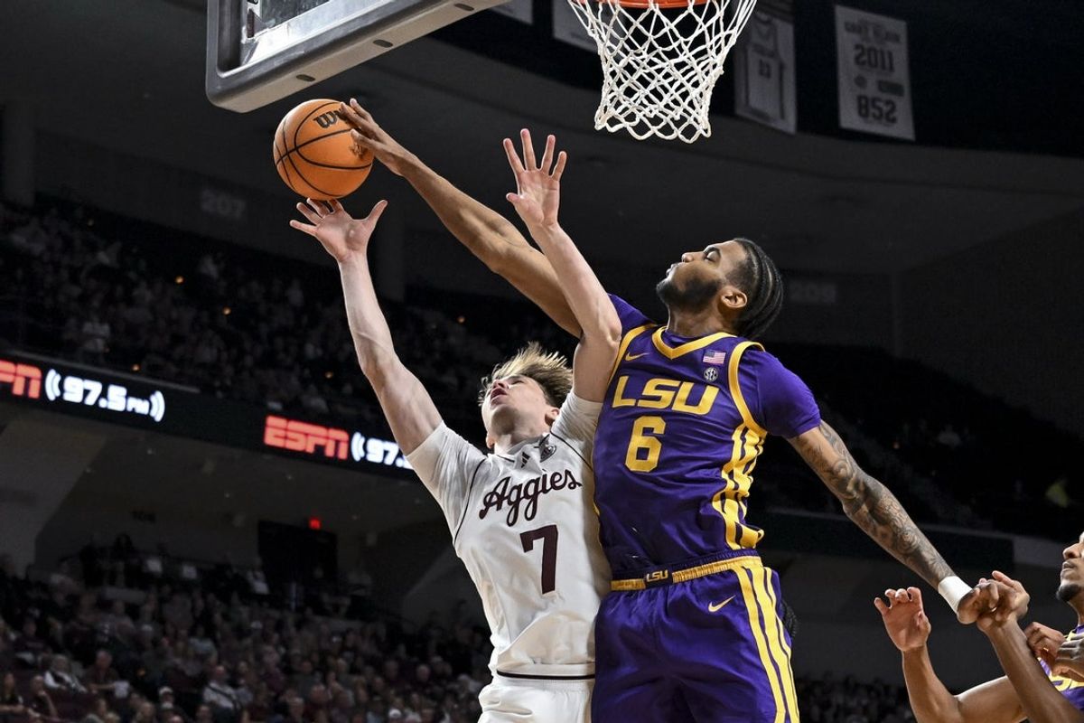 Jan 3, 2026; College Station, Texas, USA;  Texas A&M Aggies forward Zach Clemence (7) shoots during the first half as Louisiana State Tigers forward Robert Miller III (6) defends at Reed Arena. Mandatory Credit: Maria Lysaker-Imagn Images